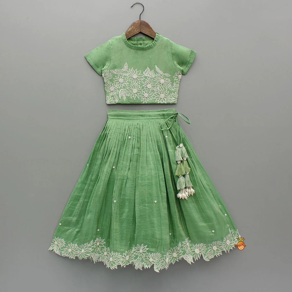 Pleated Neckline Green Shimmery Top And Fringes Tassels Enhanced Lehenga
